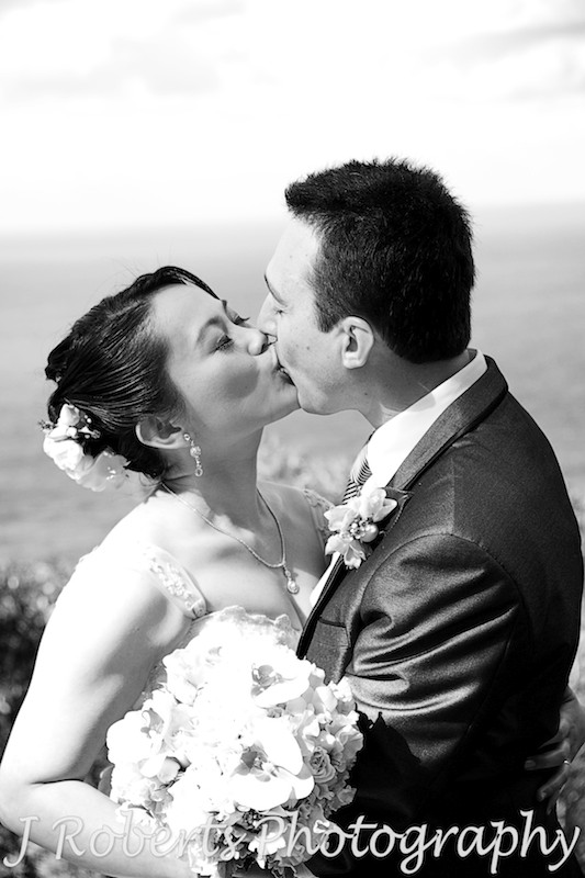 Bride and groom kissing in black and white - wedding photography sydney